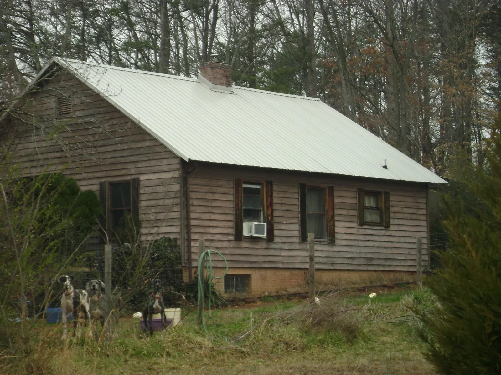 White metal roof on an old wood sided farmhouse, from a Metal Roof Installation job in Crofton